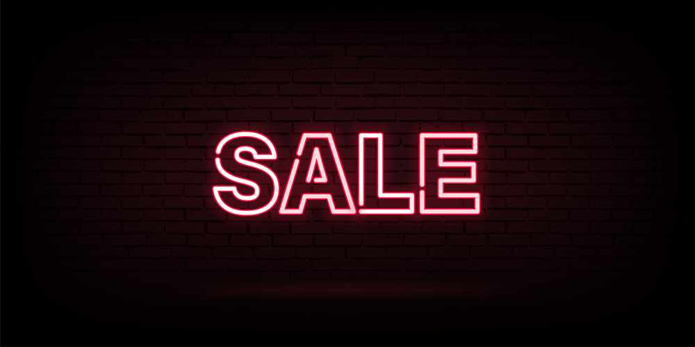 Neon sale vector advertising in led lamp shape discount concept on dark wall. Retro light gloving text offer graphic illustration.