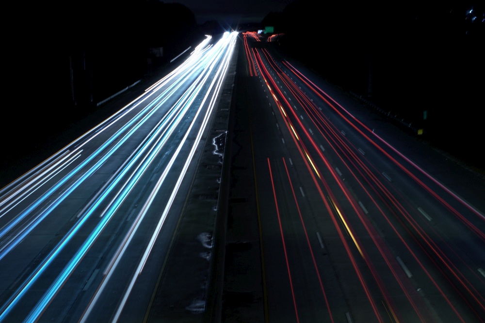 An overhead shot of a highway road with car light speed trails. Overhead shot of a highway road with car light speed trails