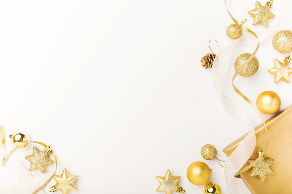 Christmas background. Flat Lay with Christmas golden deco baubles on white. Copy Space. Horizontal.