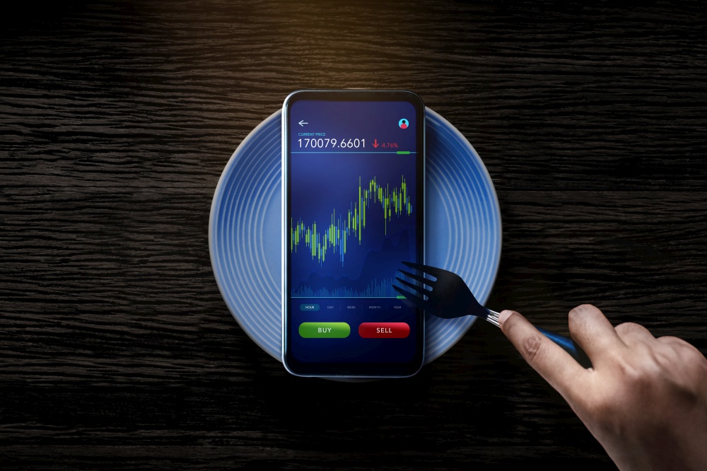 Metaphor Conceptual Photo. Person Using Fork to Eating Stock Market Graph on Mobile Phone. Online Investment in Daily Life. Lifestyle of Modern People. Table Top View