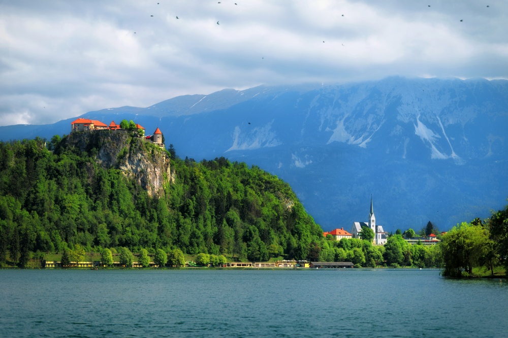 Beautiful medieval castle on Bled lake in Slovenia with mountains in background