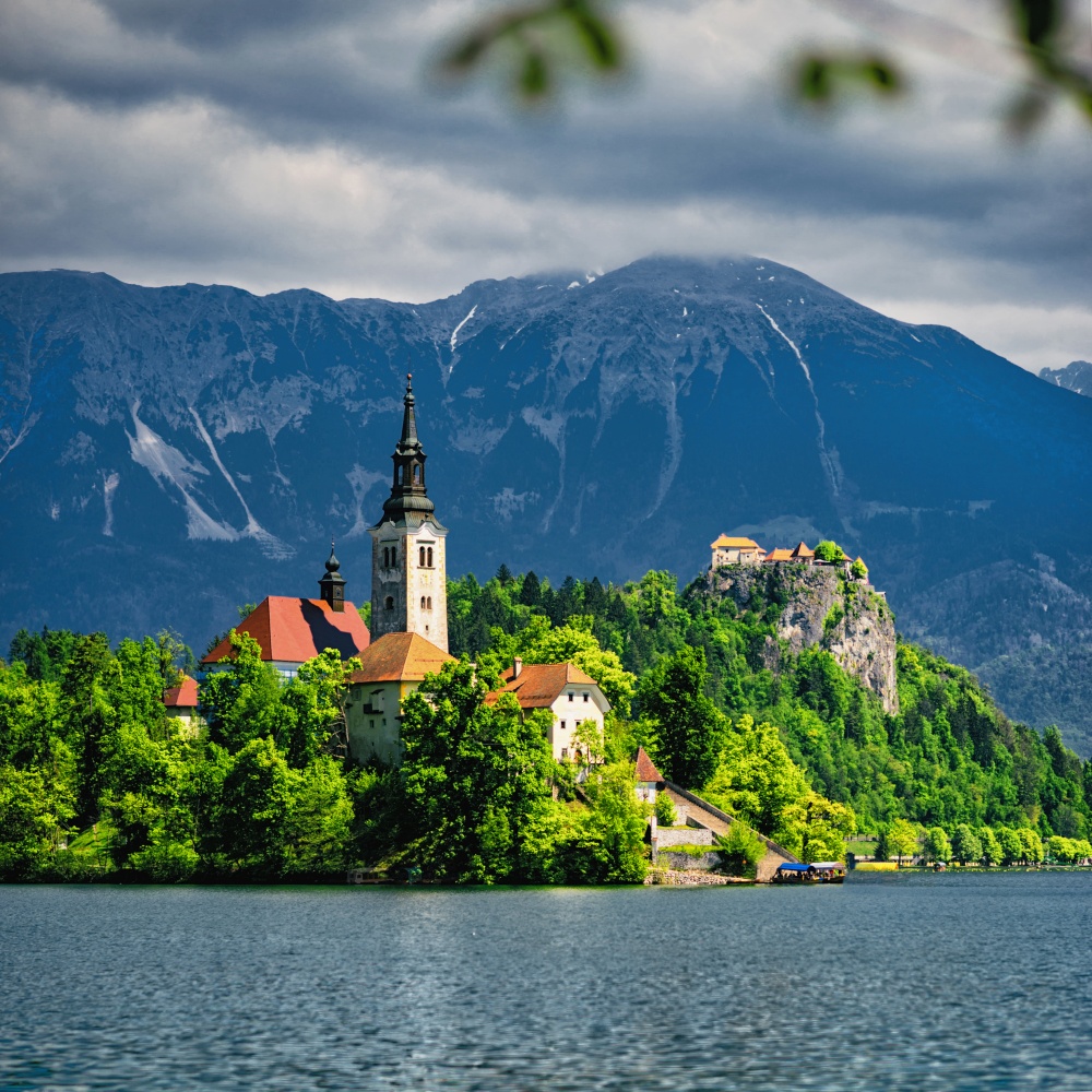 Lake Bled with the Assumption of Mary Pilgrimage Church on the small island and an ancient castle on top of the rock.