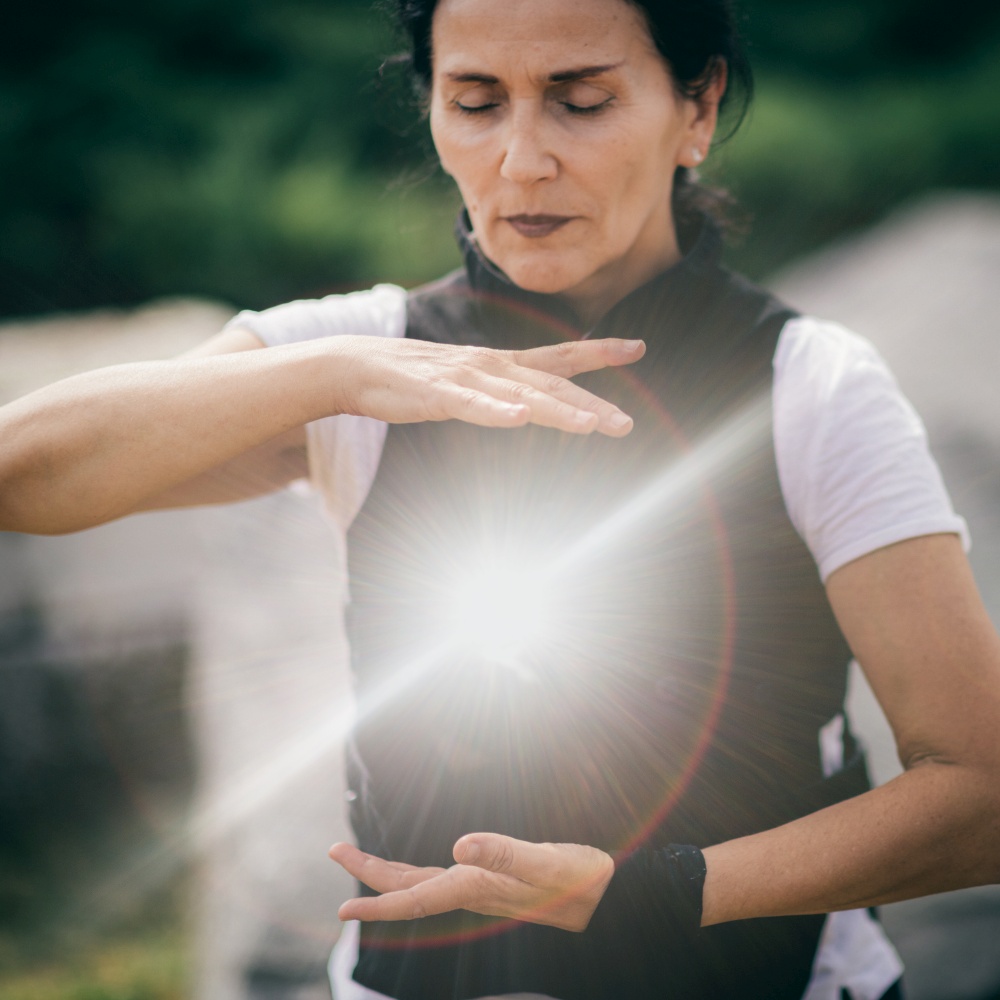 Qi Gong training outdoors, woman&rsquo;s hands in focus.. Chi Gong Practice