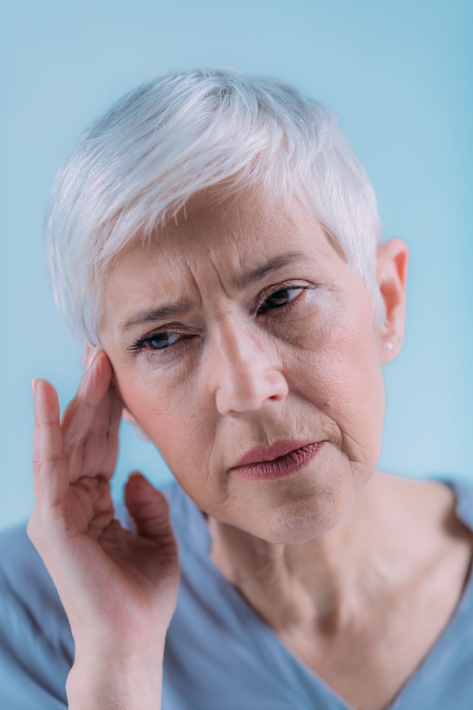 Tinnitus. Senior Woman Suffering From Tinnitus.