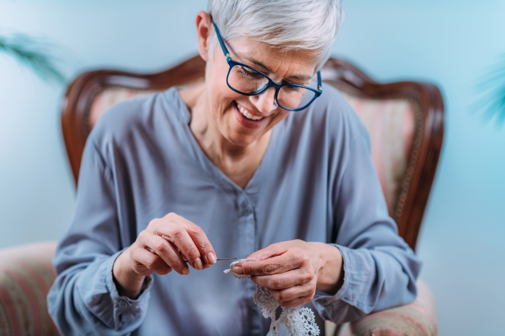 Crochet. Senior woman doing crocheting at home. Cognitive rehabilitation therapy.. Crochet. Senior Woman Doing Crocheting at Home.