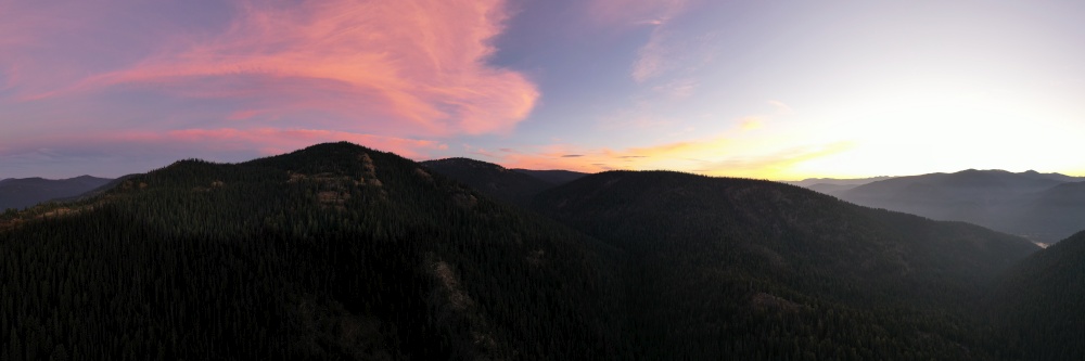 Spectacular pink sky sunrise mountain top aerial panorama