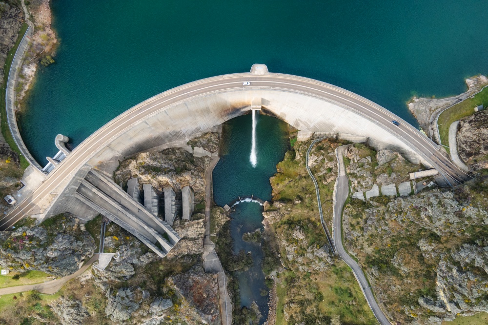 Aerial drone footage top view Water dam and reservoir lake, generating hydro electricity power renewable energy and sustainable development. High quality photo.. Aerial drone footage top view Water dam and reservoir lake, generating hydro electricity power renewable energy and sustainable development. High quality photo