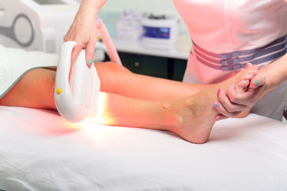 Laser epilation and cosmetology in beauty salon. Cosmetology, spa and hair removal concept. High quality photo. Laser epilation and cosmetology in beauty salon. Cosmetology, spa and hair removal concept