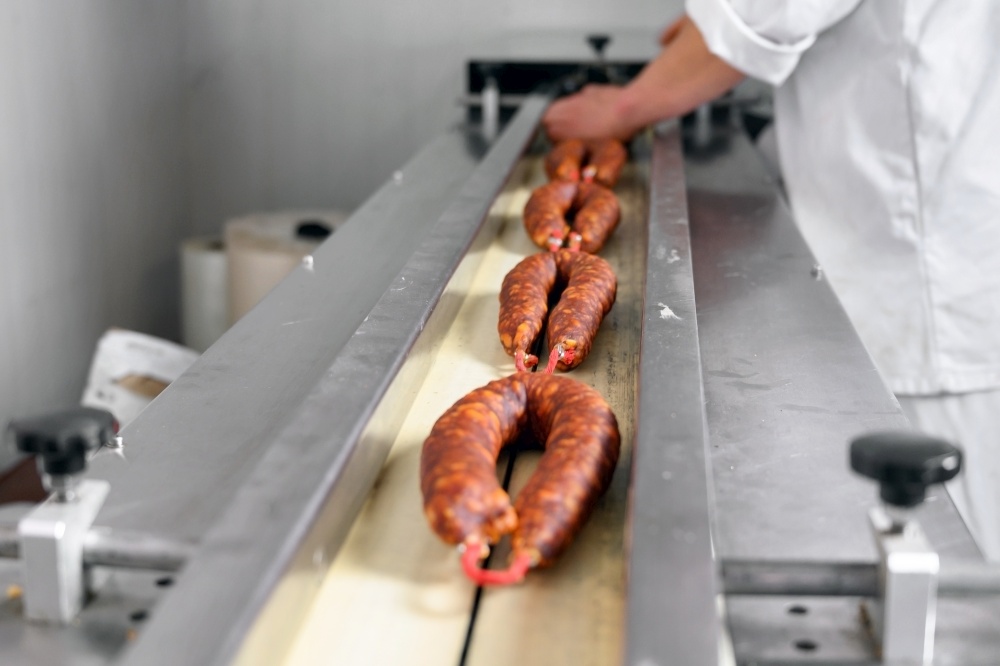 Sausages. Packing line of sausages. Industrial manufacture of sausage products. High quality photo. Sausages. Packing line of sausages. Industrial manufacture of sausage products.