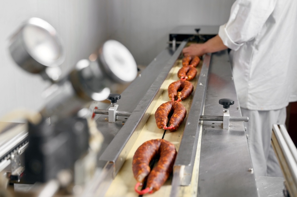 Sausages. Packing line of sausages. Industrial manufacture of sausage products. High quality photo. Sausages. Packing line of sausages. Industrial manufacture of sausage products.