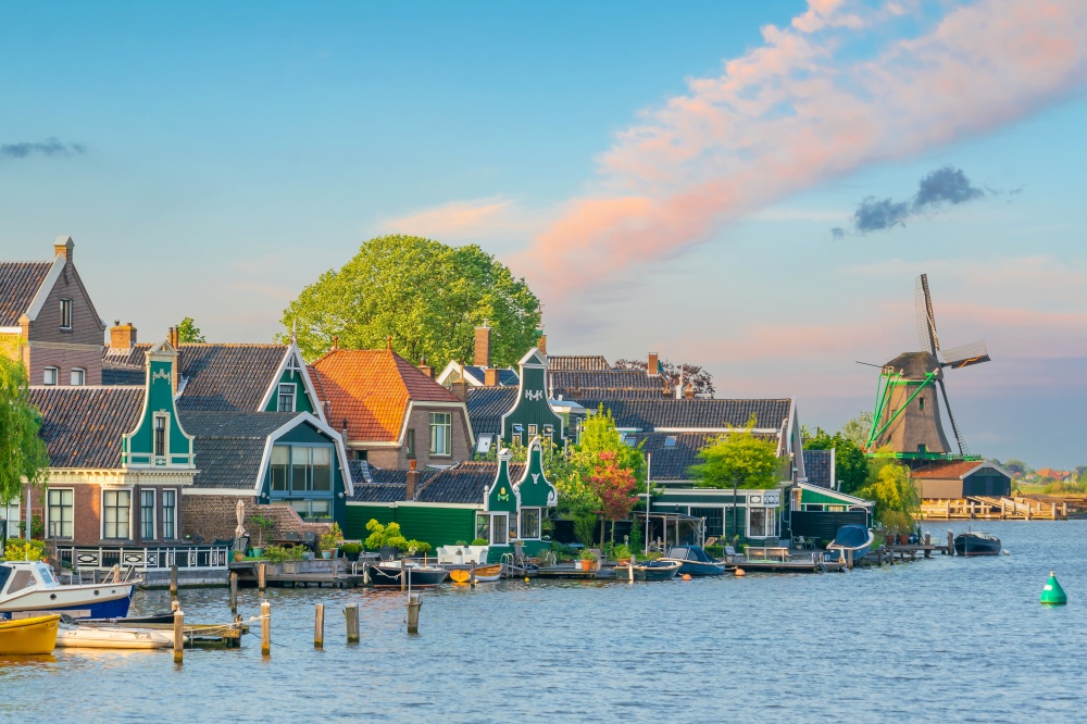 Traditional old village with dutch windmills in Amsterdam, Netherlands at sunset