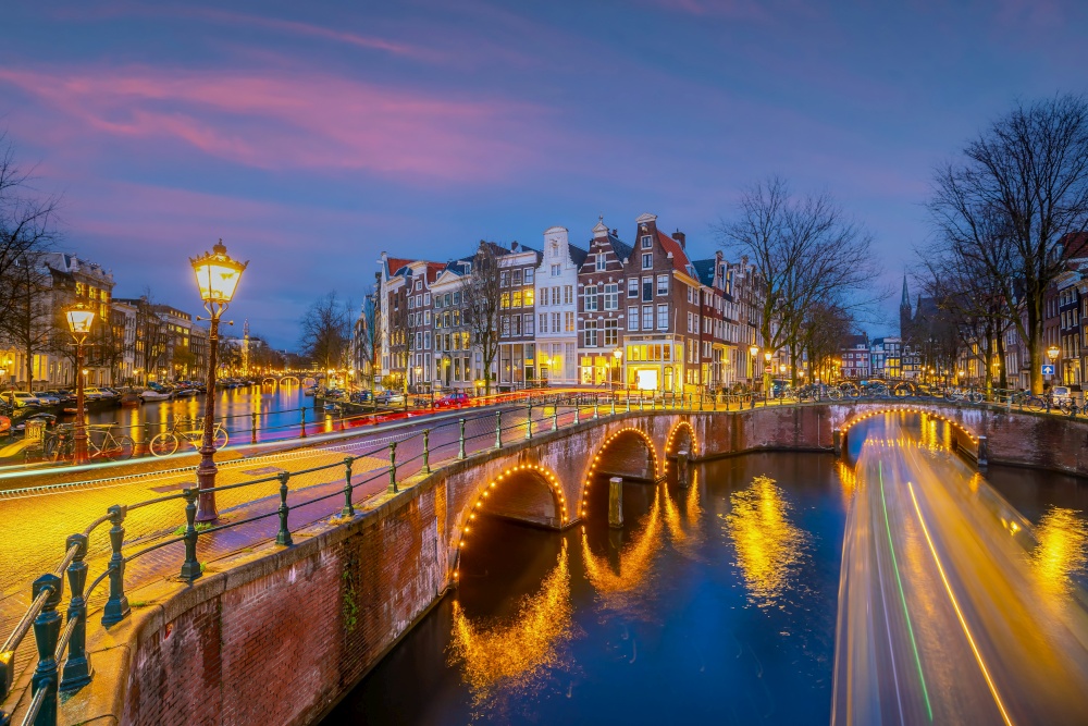 Downtown Amsterdam city skyline. Cityscape  in Netherlands at sunset