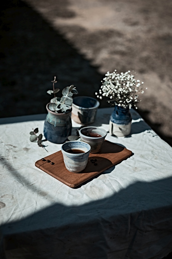 A cup of aromatic black coffee and coffee beans on the table. . A cup of aromatic black coffee