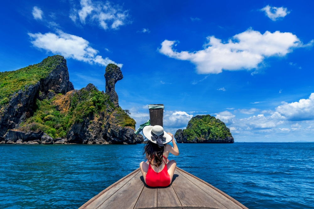 Beautiful girl in red bikini on boat at Koh Kai island, Thailand.