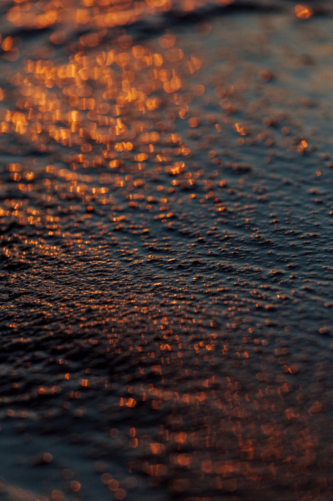 A super close up of the sand as the background with super texture on dark tones and minimalistic view, background, copy space, orange, black, blue