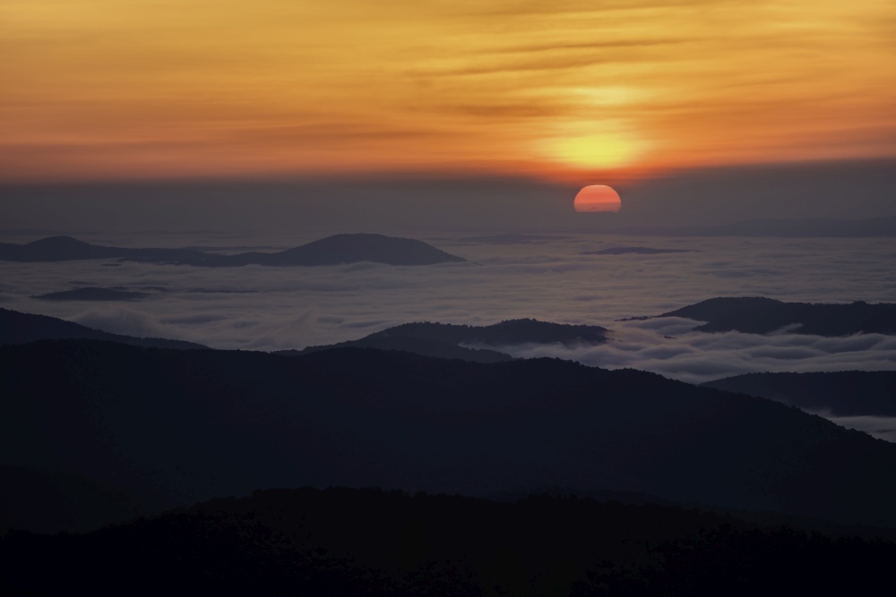 The sun rising over a sea of fog taken from Shenandoah National Park in Virginia on an early June morning.