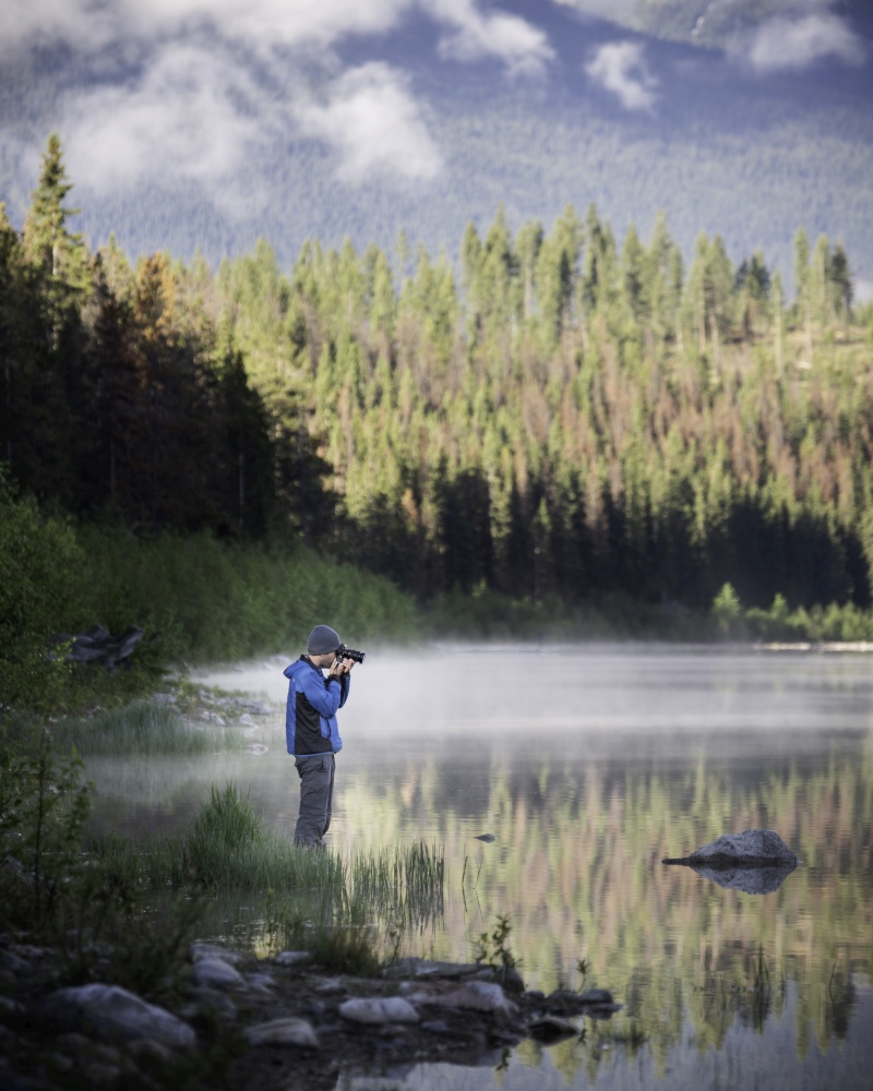 A photographer lines up his shot on a beautiful sunny morning in Jasper National Park.