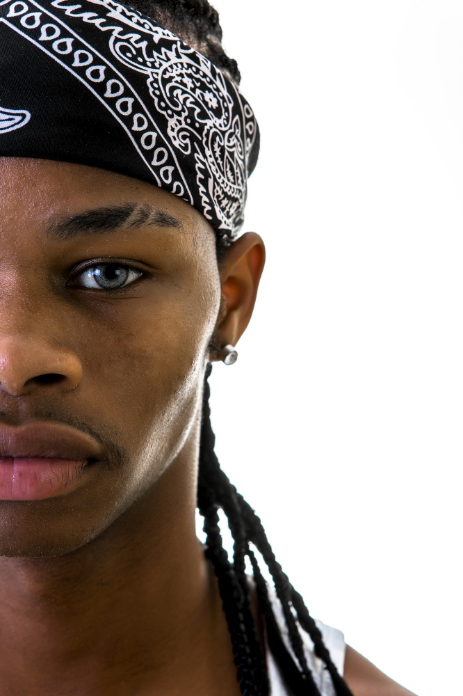 Crop young black man with do-rag looking at camera isolated?on white.. Crop man with do-rag in studio