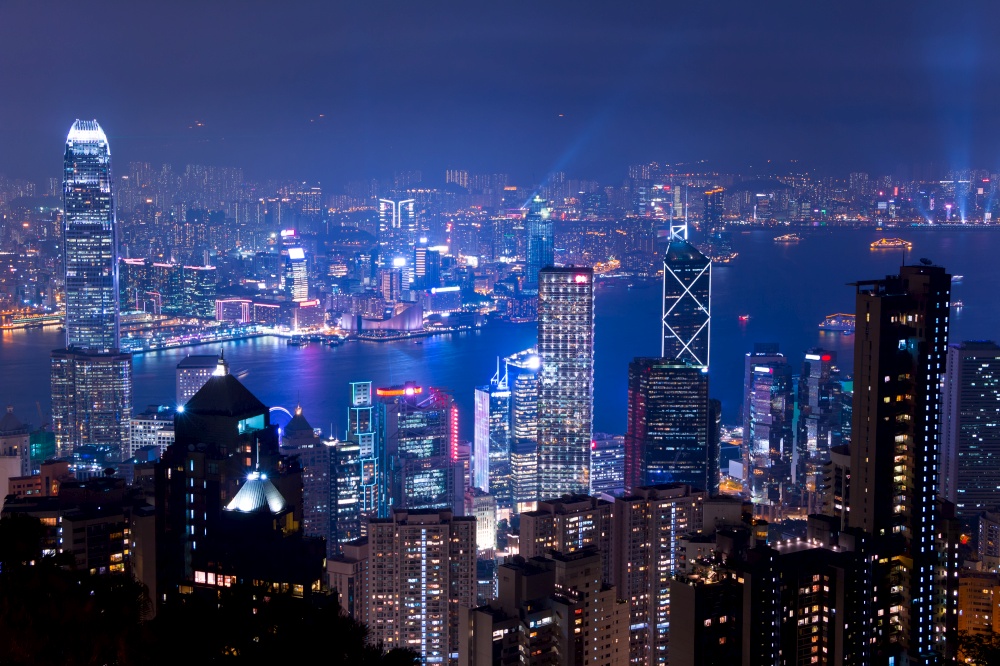 Panoramic view of Hong Kong from the top point (Victoria Peak). Night with the glow of the city lights and the Light Show. Night over Hong Kong