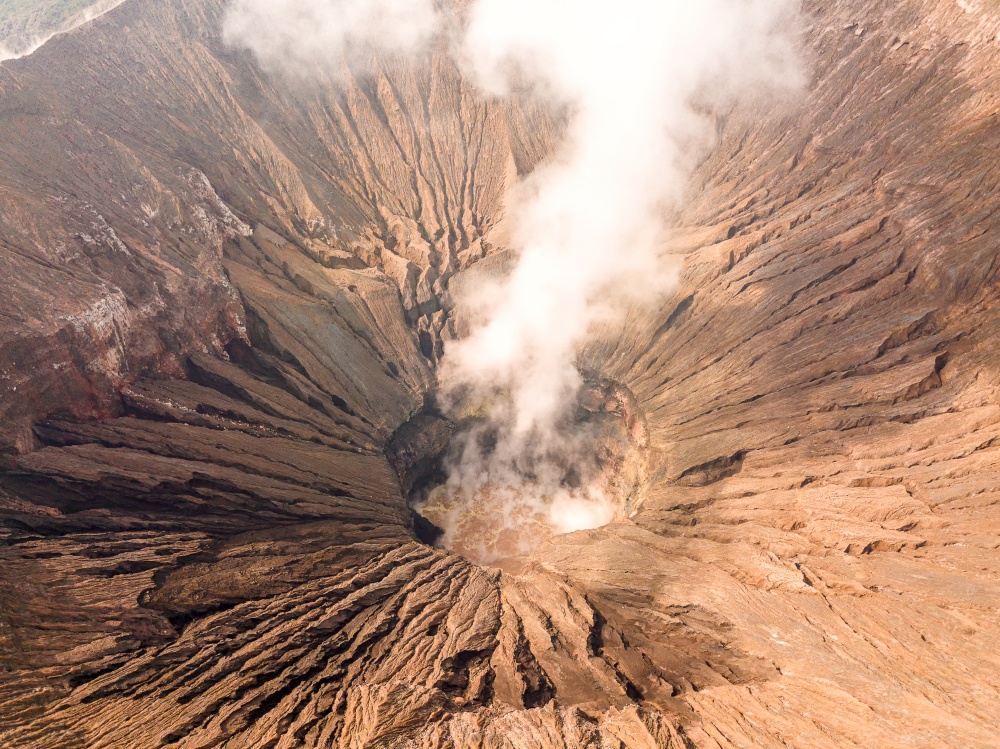 Indonesia. Java island. The active volcano Bromo. Aerial view of the slopes of the crater and smoke. Crater of an Active Volcano. Aerial View