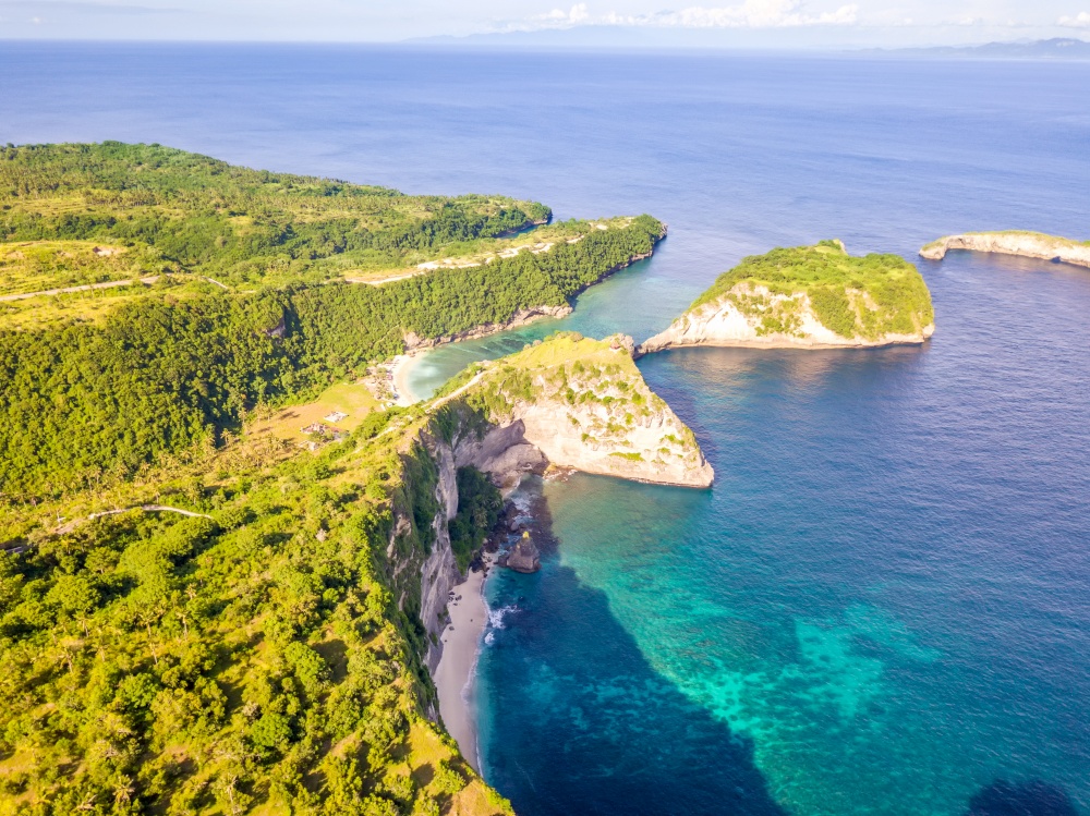 Indonesia. Rocky tropical coast of Penida Island and two small beaches, ocean and sunny weather. Aerial view. Rocky Tropical Shore and Beaches. Aerial View