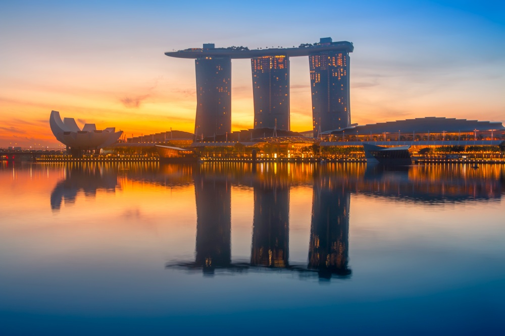 Singapore. Marina Bay Sands Hotel. Colorful sunrise and calm water of the bay. Marina Bay Sands at Dawn
