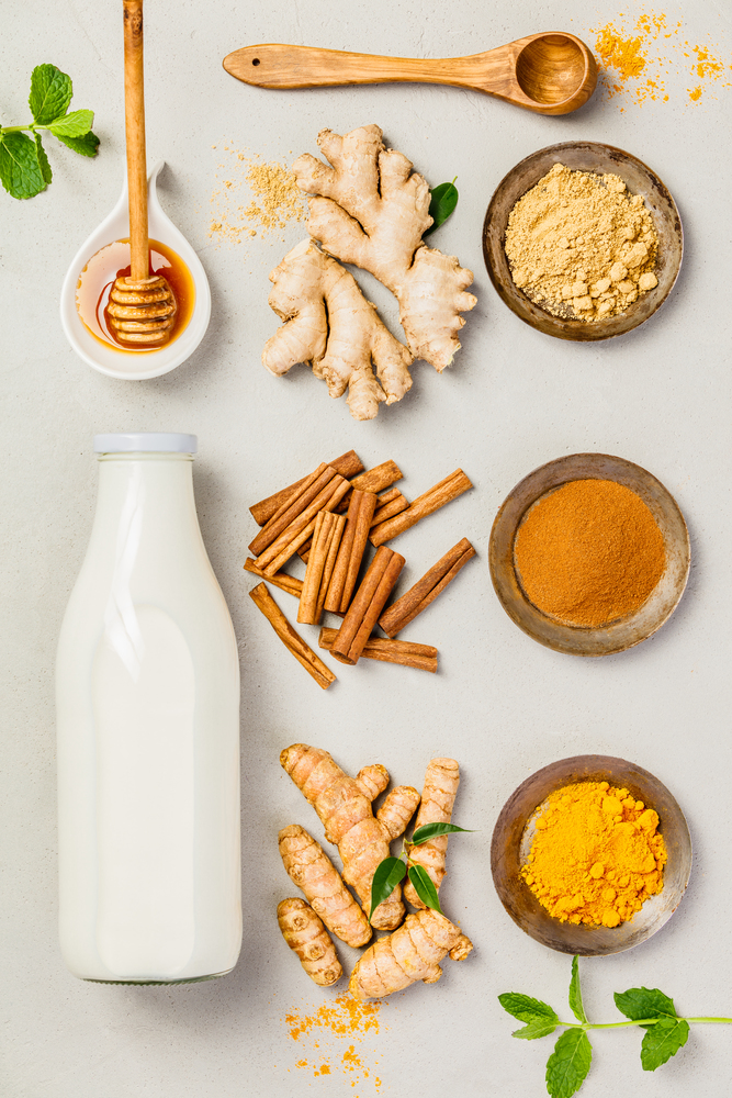 Ginger, turmeric, cinnamon, mint, honey and milk. Ingredients  for healthy drinks - turmeric tea or golden turmeric latte. Top view, copy space