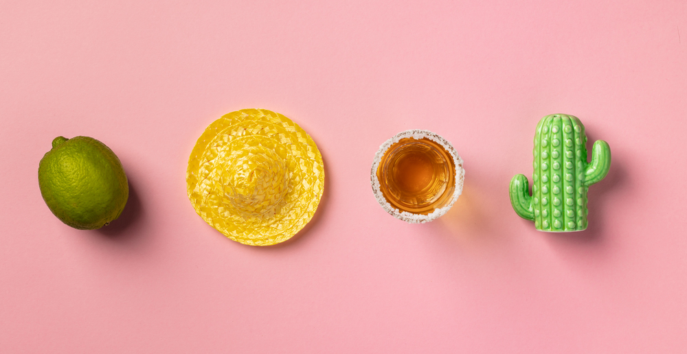 Sombrero, lime, tequila and cactus on pink background. Creative mexican tradition concept. Flat lay composition