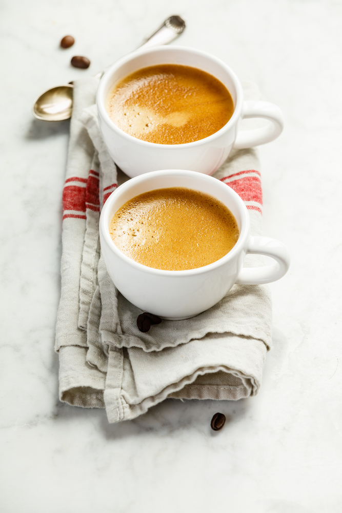 Coffee composition on white marble background. Coffee espresso in white cups