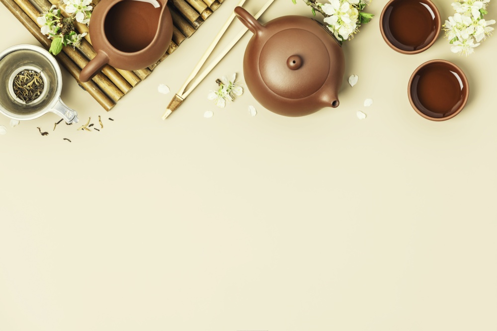 Asian Tea set on stone slate board, ceramic teapot, cups, dried tea and spring branches, tea ceremony, flat lay. Asian Tea set on stone slate board, ceramic teapot, cups, dried tea and spring branches