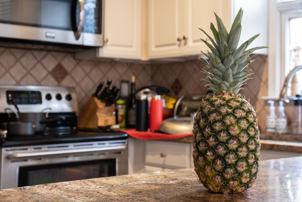 Interior of a kitchen with a pineapple on the foreground