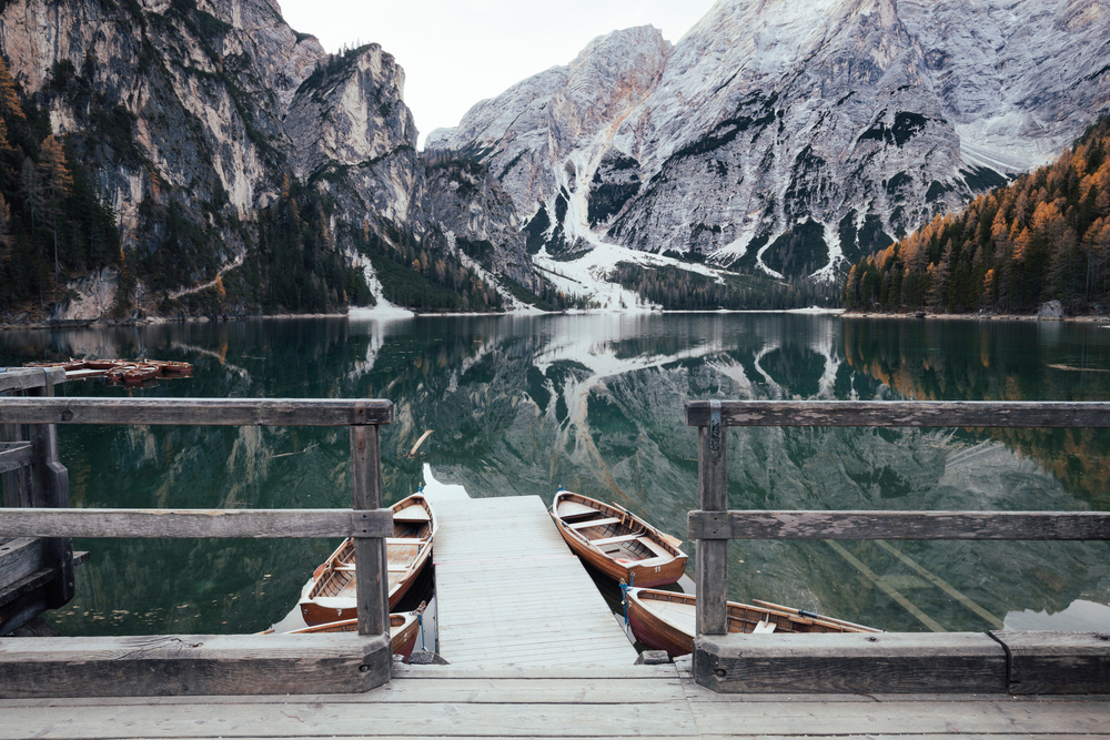 Wooden boats at the alpine mountain lake. Lago di Braies, Dolomites Alps, Italy. Wooden boats at the alpine mountain lake