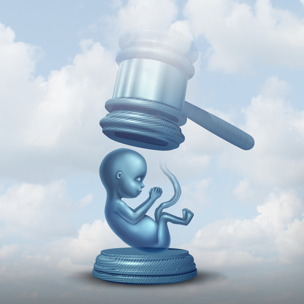 Abortion laws and legislation on unborn baby as a fetus with a justice judge gavel representing the social issue and concept of rights with 3D illustration elements.
