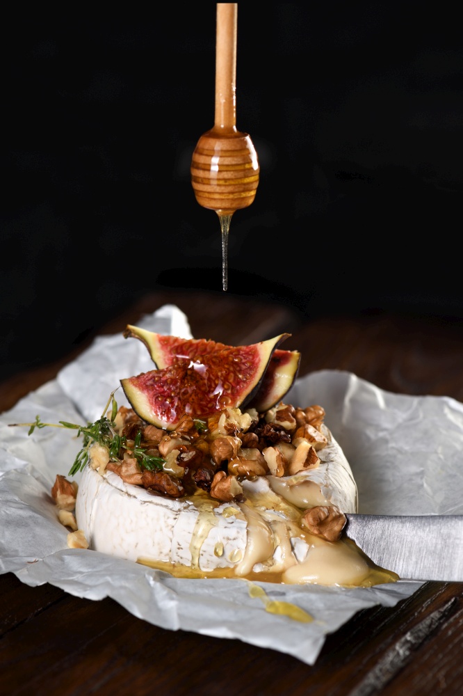 Baked camembert with nuts and honey, fig and thyme slices.