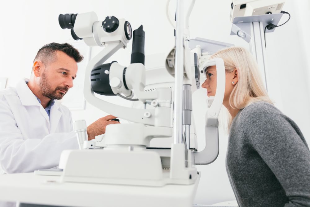 Optician checking woman&rsquo;s eyesight with special equipment. Medicine, healthcare.. Optician checking woman&rsquo;s eyes with special equipment.