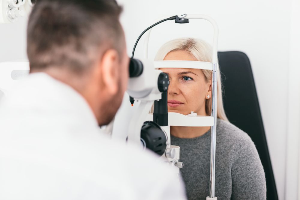 Woman undergoing eyesight exam in optician&rsquo;s office. Ophthalmology, vision examination and treatment.. Woman undergoing eyesight exam in optician&rsquo;s office.