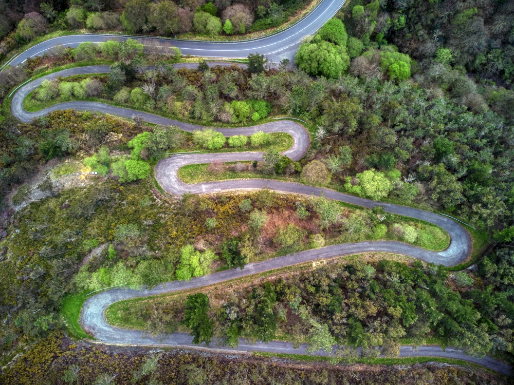 Aerial view of winding road in spring in Asturias, Spain.