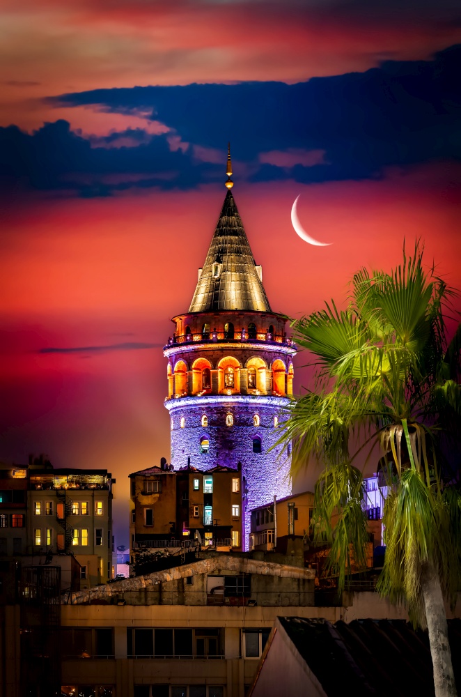 Illuminated Galata Tower in Istanbul at night, Turkey. Galata Tower and moon