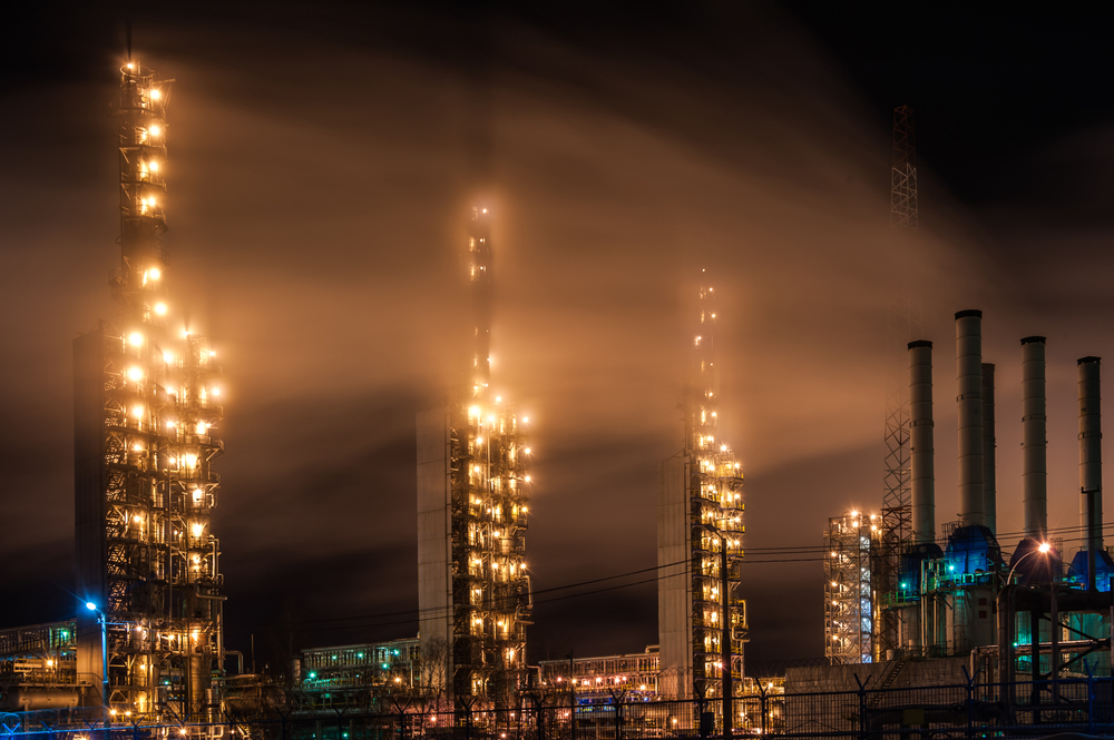 Chemical industry distillation towers detail at night. Petrochemical background. Long exposure at winter dusk. Oil and gas concept. Russia, Western Siberia.. Chemical industry distillation towers detail at night. Petrochemical background. Long exposure at winter dusk.