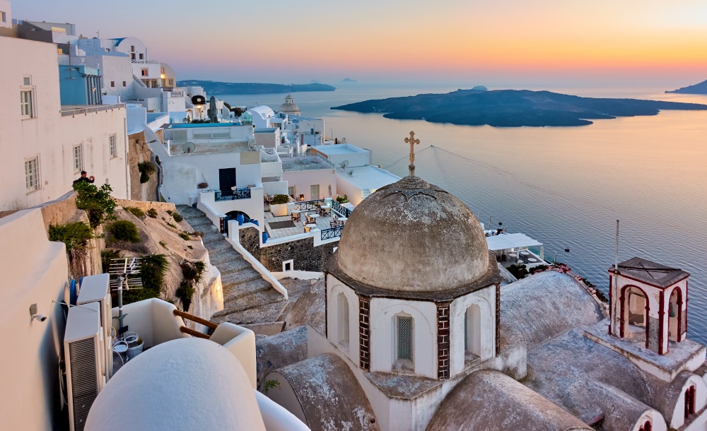 Santorini island in Greece.  Panoramic view of Fira city by the sea at sunset. Greek landscape