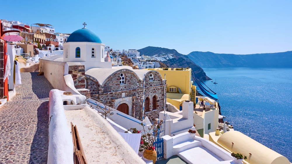 Greece, Santorini island. Scenic panoramic view with street and ancient greek church in Oia town