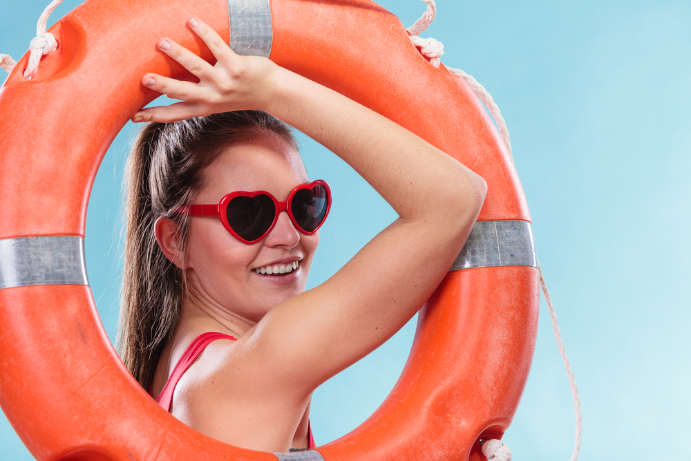 Happy woman girl in heart shape sunglasses with ring buoy lifebuoy.. Happy woman in sunglasses with ring buoy lifebuoy.