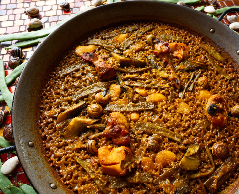 Valencian Paella with chicken rabbit artichokes beans and snails