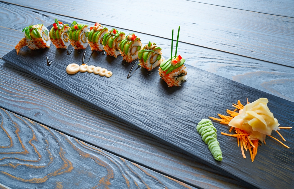 Dragon shape Sushi rice roll with nori prawn avocado sesame and teriyaki