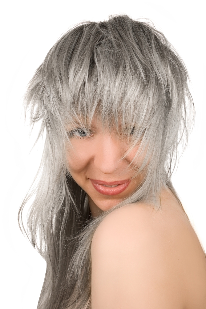 Beautiful lovely girl with tousled silver hair on white