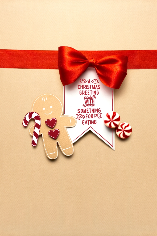 Creative concept photo of christmas candy and  gingerbread man on brown background.