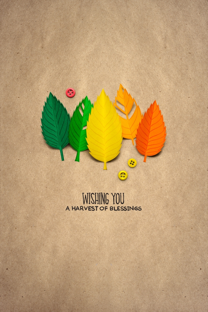 Creative thanksgiving day concept photo of leaves made of paper on brown background.