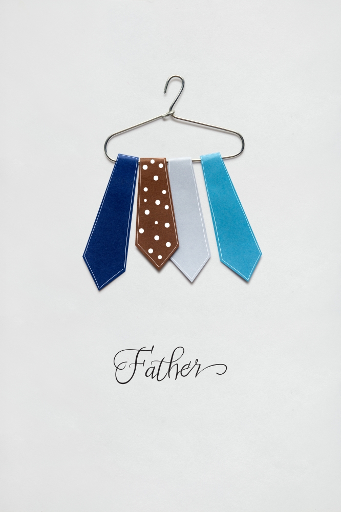 Creative concept photo of ties on a hanger made of paper on white background.
