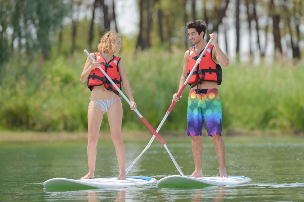 silhouette of perfect couple engage standup paddle boarding