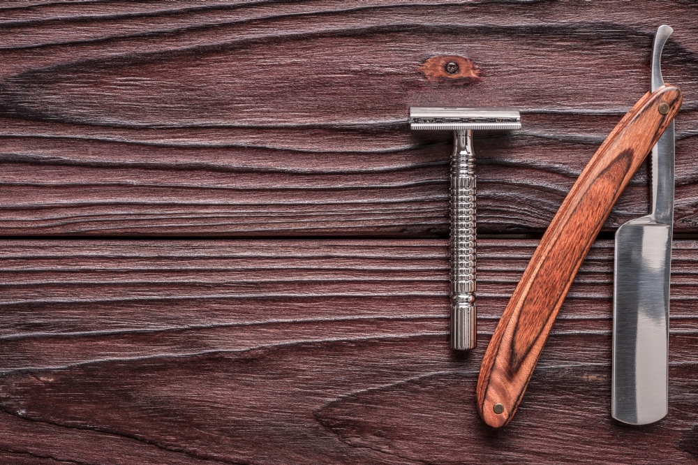 Vintage barber shop razor tools on wooden background. Vintage barber shop razor tools on old wooden background